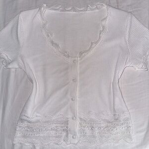 lace v cut neck top with lace at the bottom and the sleeves. cute and coquette.